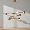 Prestige Lighting Kuzco Reese 47.5 in Linear LED Chandelier in Vintage Brass with Amber Glass Shades, front view